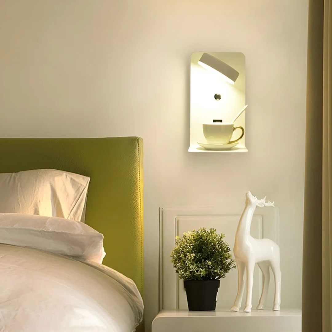 Moderne Nachttischlampe mit Tasse, grünem Kopfteil und Dekofigur im Schlafzimmer.