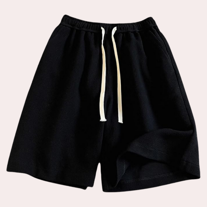 Schwarze Baumwollshorts mit weißem Kordelzug, lässige Herrenmode, bequem und stilvoll.