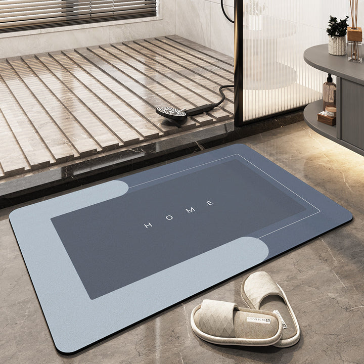 Graue Badematte mit "HOME"-Aufschrift, rutschfest, saugfähig, Badezimmer, modern, rechteckig.