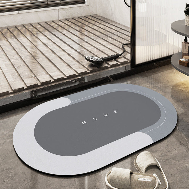 Grauer rutschfester Badezimmerteppich oval, mit "Home" Schriftzug, moderne Badezimmerdekoration.
