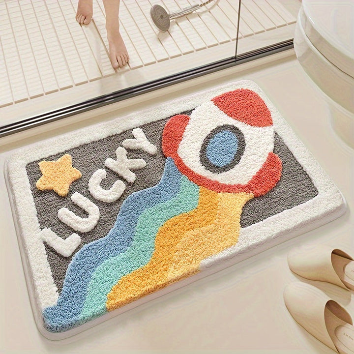 Bunte Badematte mit Raketenmotiv und "Lucky"-Schriftzug im Badezimmer, rutschfest, saugfähig.