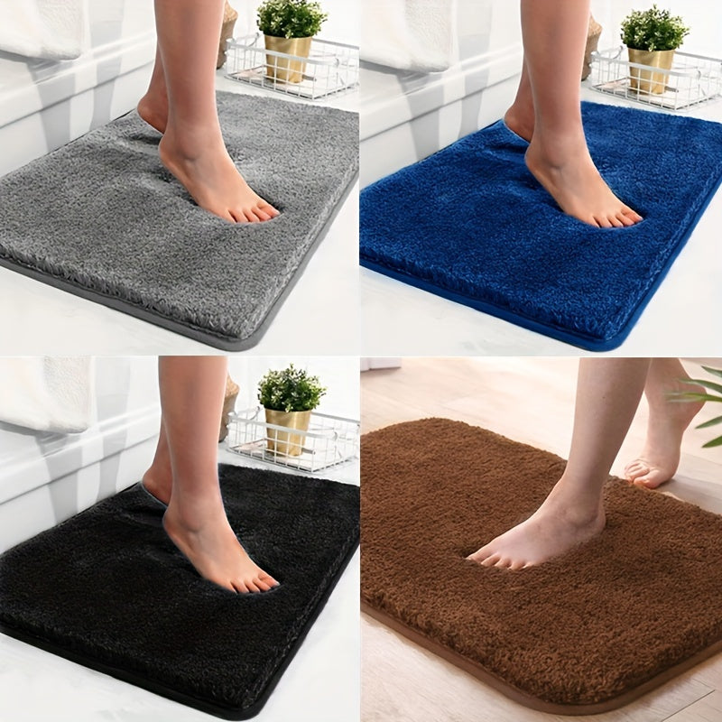 Vier rutschfeste Badematten in Grau, Blau, Schwarz und Braun, weiches Mikrofaser-Material.