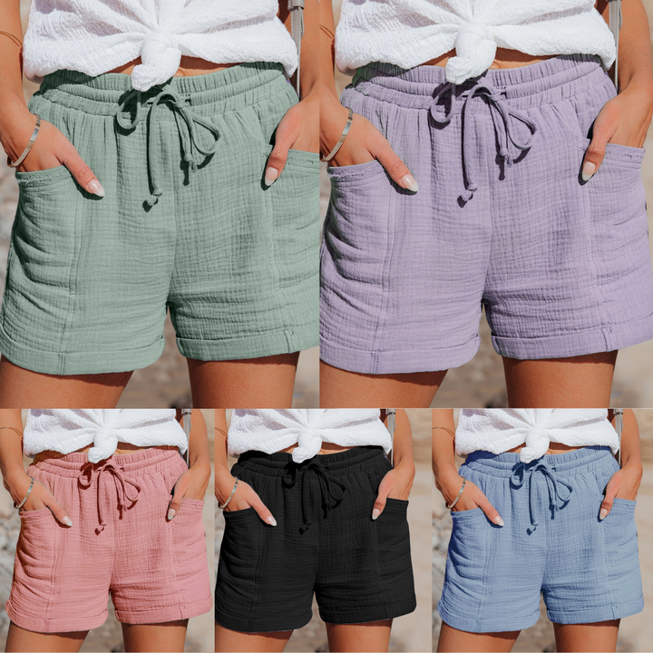 Fünf Damen-Shorts aus Baumwolle in Grün, Lila, Rosa, Schwarz und Blau mit Taschen und Kordelzug.