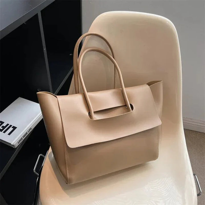 Beige Lederhandtasche auf Stuhl, elegantes Design, Damenmode, geräumig, stilvoll, modern.