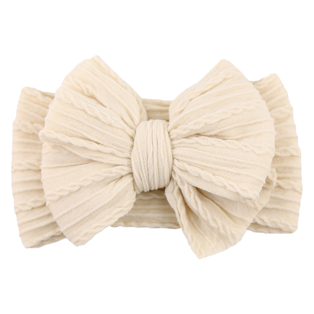 Beige Baby-Stirnband aus Baumwolle mit großer Schleife, geripptes Design, modisches Accessoire.