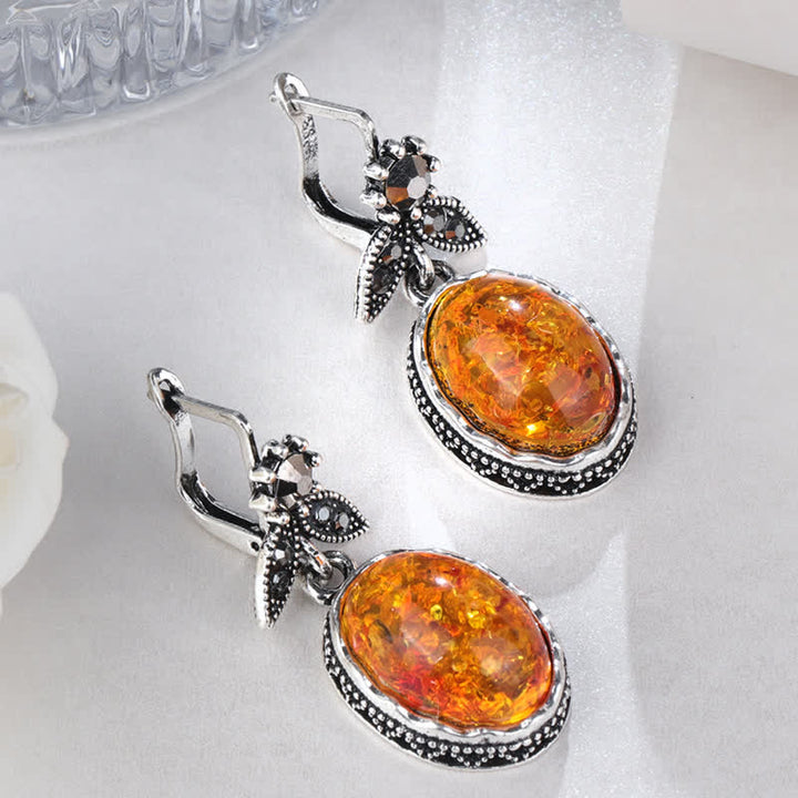 Silberne Ohrringe mit ovalem Bernstein, florales Design, eleganter Schmuck für Damen.