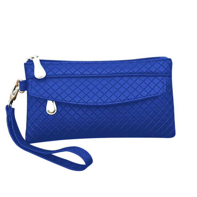 Blaue Damenhandtasche mit Rautenmuster, Reißverschluss und Handgelenkschlaufe.