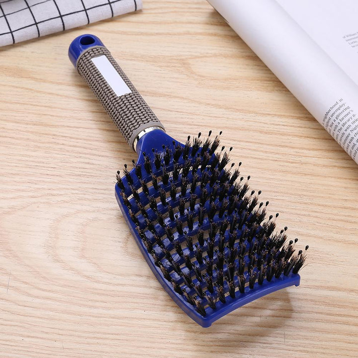 Blaue Haarbürste mit Nylonborsten, ergonomischer Griff, ideal für Styling und Entwirren.
