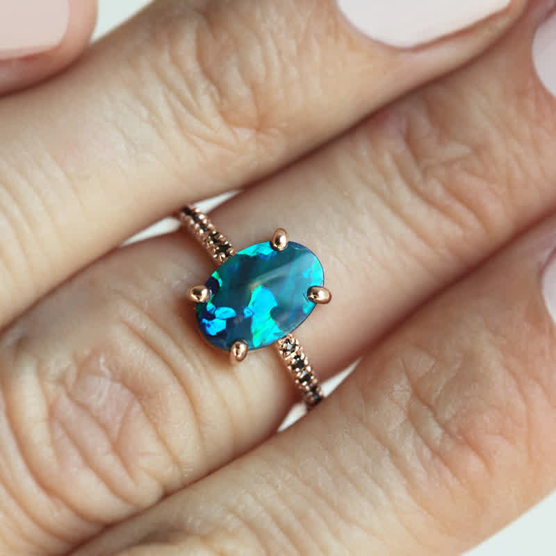 Opalring mit blauem Edelstein, Roségold, elegantes Schmuckdesign, Damenmode.