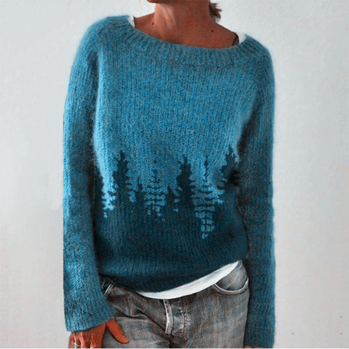 Blaue Strickjacke mit Waldmotiv, Damenmode, weiches Material, lässiger Stil.
