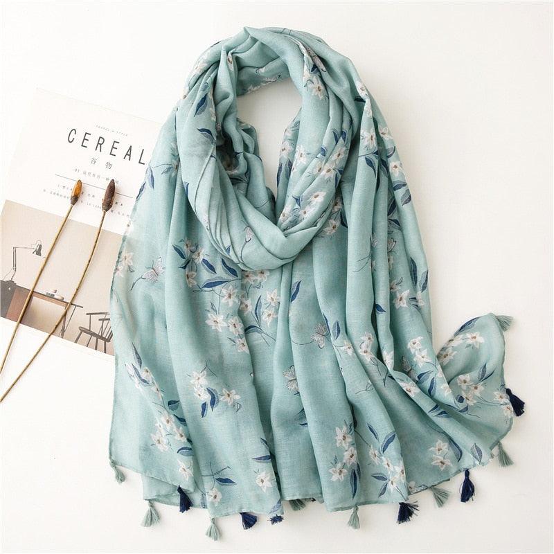Hellblauer Schal mit Blumenmuster, weicher Stoff, modisches Accessoire, Damenmode.