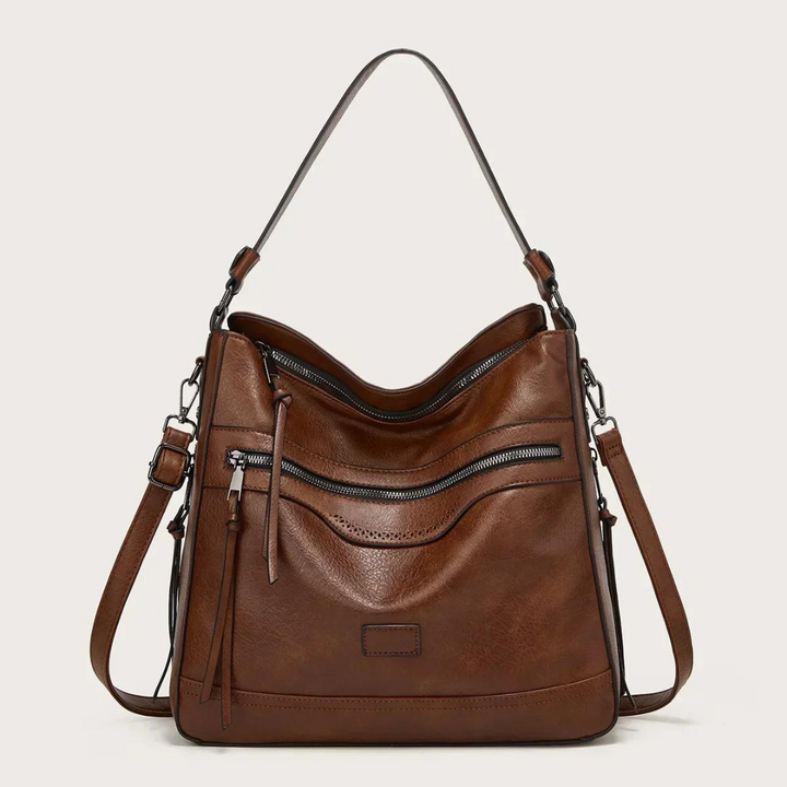 Braune Lederhandtasche mit Reißverschlusstaschen und verstellbarem Schulterriemen.
