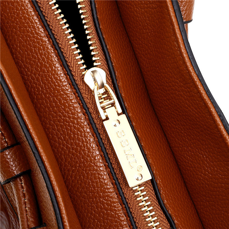 Braune Ledertasche mit goldfarbenem Reißverschluss, Nahaufnahme, hochwertige Handtasche.
