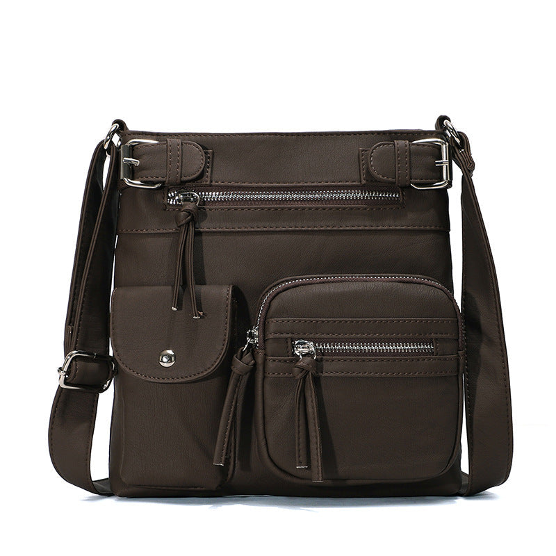 Braune, multifunktionale Anti-Diebstahl-Tasche aus Leder mit mehreren Reißverschlusstaschen.