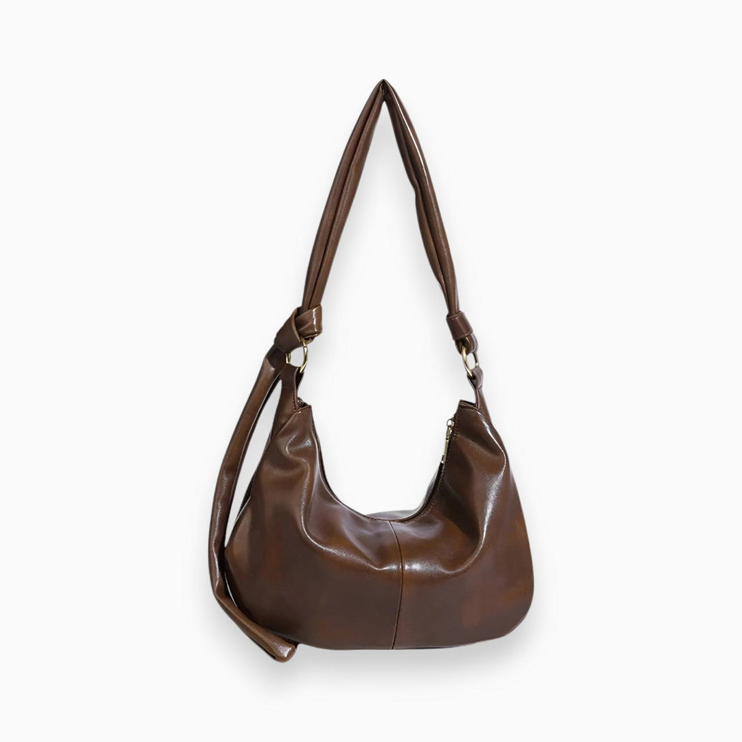Braune Lederhandtasche mit Schulterriemen, modisches Accessoire, Damenmode, elegant.