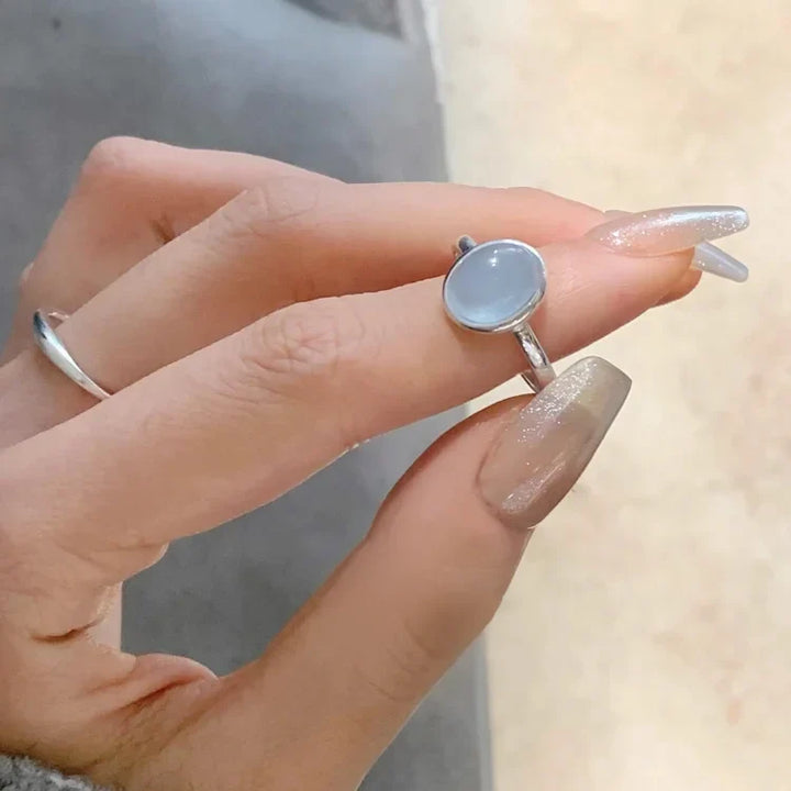 Silberring mit blauem Edelstein, elegantes Design, Damenmode, Schmuckaccessoire, Handaufnahme.