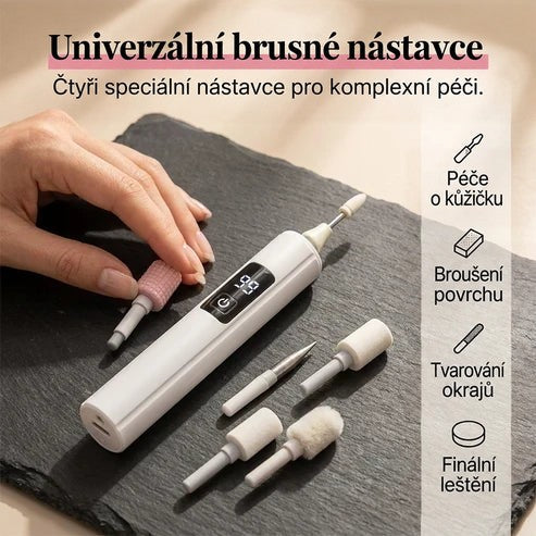 Ruka bere růžový nástavec, na břidlicové desce leží přístroj a další brusné hlavice 3