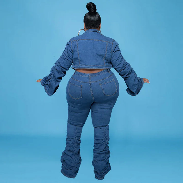 Frau in blauer Jeansjacke und Schlaghose, Rückansicht, Plus-Size-Mode, blauer Hintergrund.