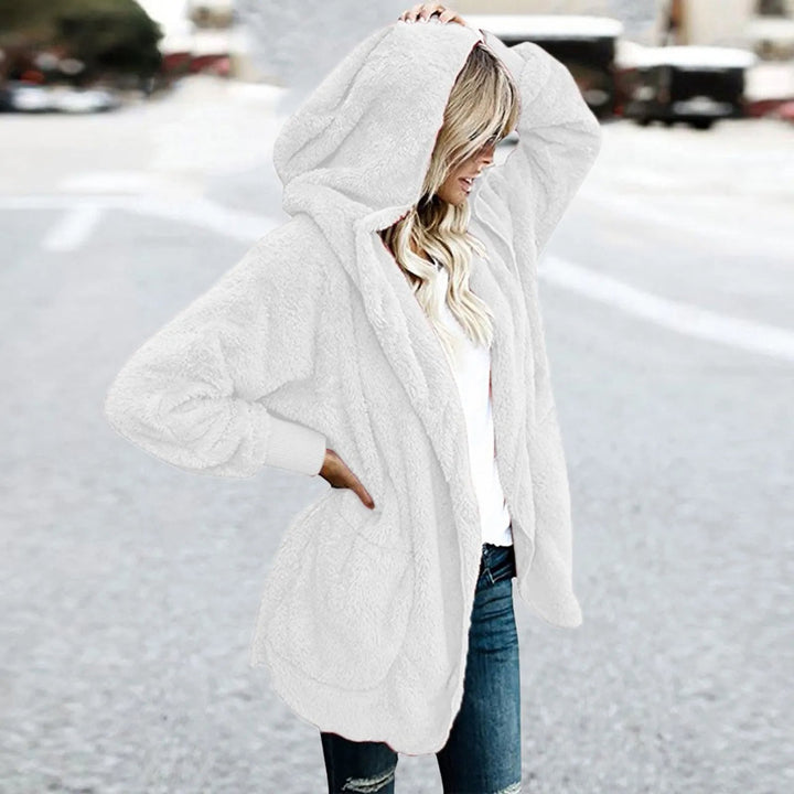 Frau in weißem Fleece-Hoodie auf Straße, Wintermode, gemütliche Damenbekleidung.