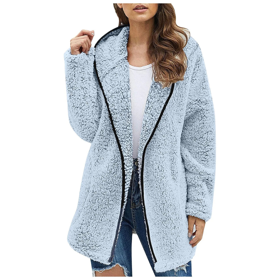 Frau in hellblauer Teddyjacke, Reißverschluss, Kapuze, lässiger Stil, Wintermode, Damenbekleidung.