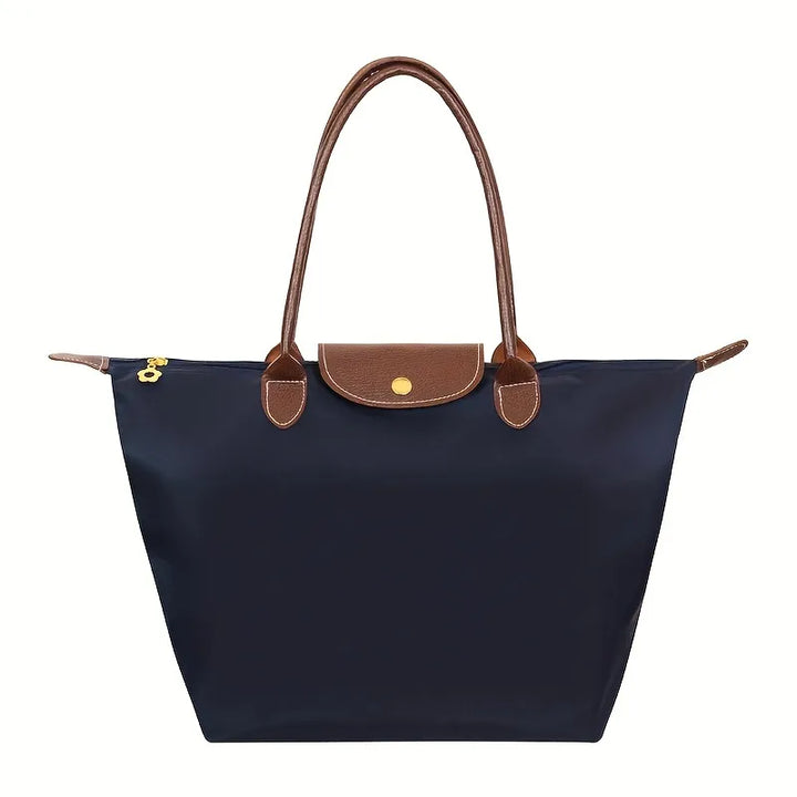 Dunkelblaue Damenhandtasche, Ledergriffe, modisch, geräumig, elegant, Alltagsgebrauch.