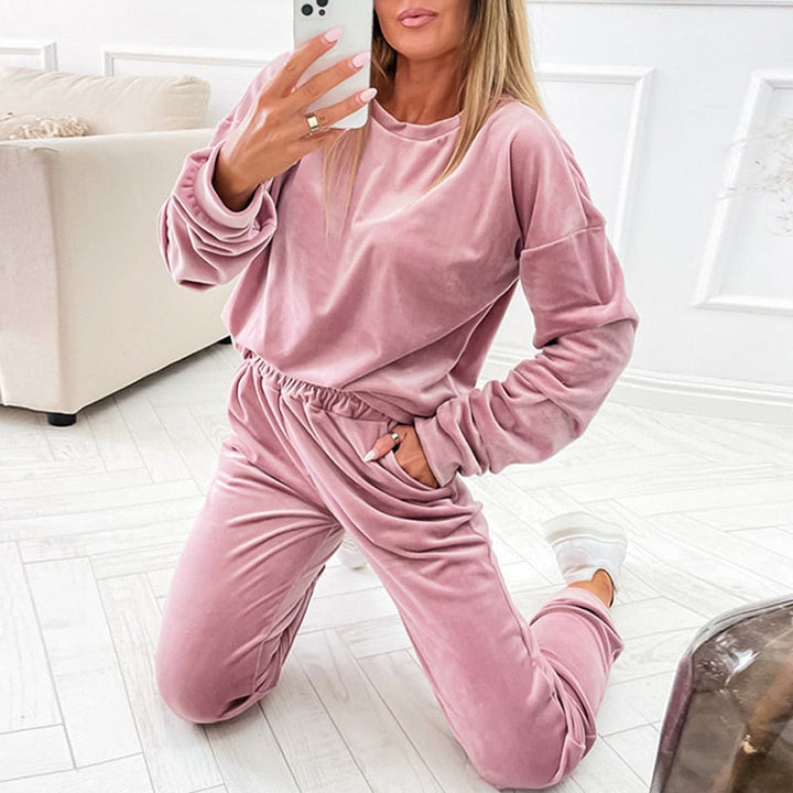 Frau in rosa Samt-Trainingsanzug, gemütlich, modisch, Selfie, Wohnzimmer, Freizeitkleidung.