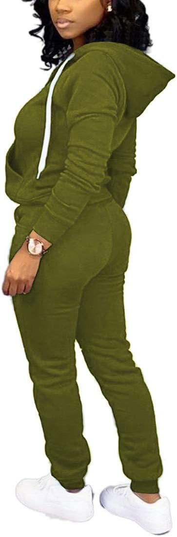 Frau in olivgrünem Jogginganzug mit Kapuze, weiße Sneaker, sportlich, bequem, Freizeitmode.