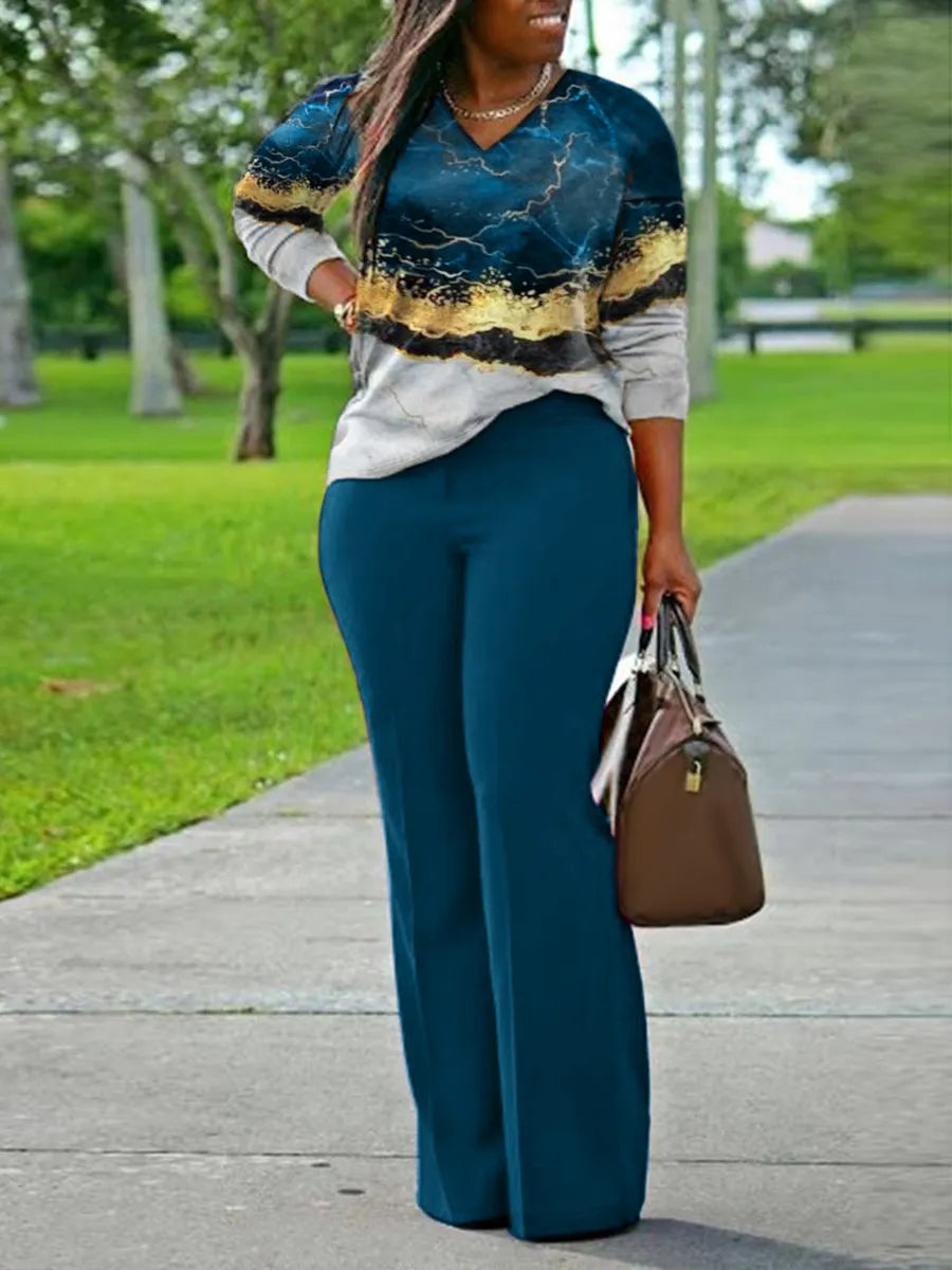 Frau in blauer Hose und gemustertem Pullover, braune Handtasche, Spaziergang im Park.