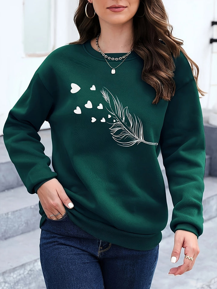 Frau in grünem Pullover mit Feder- und Herzmotiv, lässige Mode, Herbstkleidung, Damenmode.