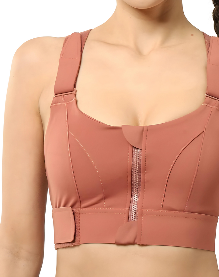Frau in rosa Sport-BH mit Reißverschluss, Fitnessbekleidung, bequemer Halt, atmungsaktiv.