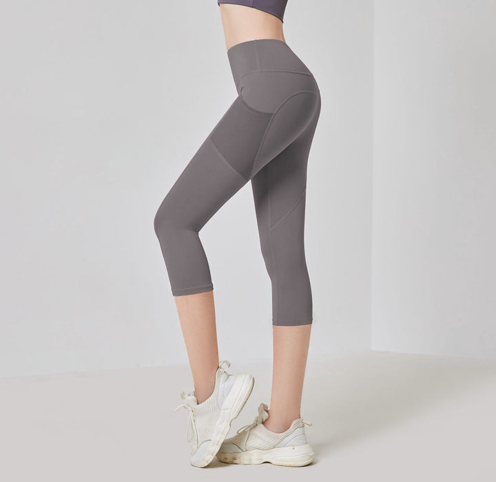 Dunkelgraue Damen-Leggings, knielang, sportlich, elastisch, ideal für Fitness und Yoga.