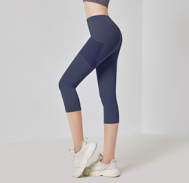 Dunkellila Damen-Sportleggings, knielang, hoher Bund, atmungsaktiv, für Fitness.