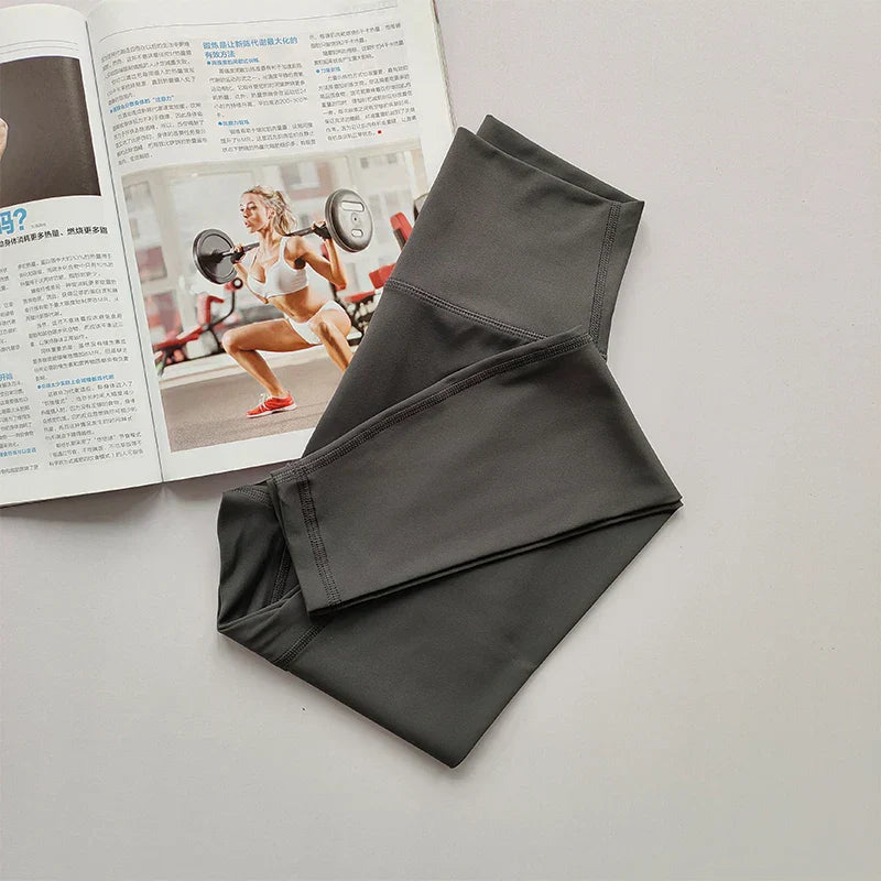 Graue Sportleggings auf Magazin mit Fitnessmotiv, Damenbekleidung, elastisch, bequem.