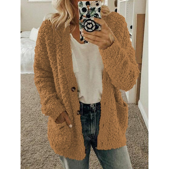 Frau in brauner Strickjacke, weißem T-Shirt, Jeans, Selfie, gemütliche Herbstmode.