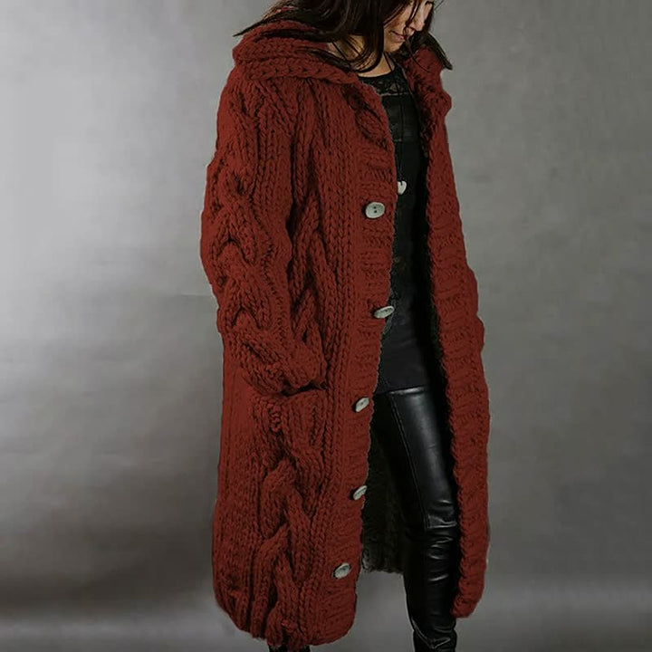 Frau in rotem Strickmantel mit Zopfmuster, Kapuze und Knöpfen, modisch, warm, Winterkleidung.