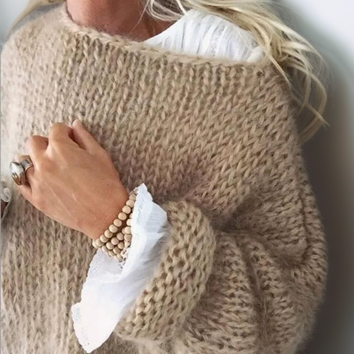 Frau in beigem Strickpullover mit weißer Bluse und Holzarmband, modisch, gemütlich, Herbstmode.