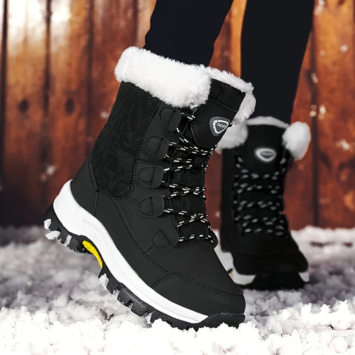 Schwarze Damen-Winterstiefel, mittelhoch, mit weißem Plüschfutter, rutschfeste Sohle.