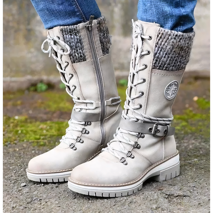 Graue Damen-Winterstiefel mit Fellbesatz, Schnürung und Reißverschluss, Outdoor-tauglich.