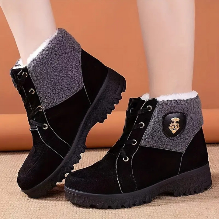Schwarze Damen-Winterstiefel mit grauem Futter, rutschfeste Sohle, warm gefüttert.