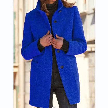 Frau in blauem Wollmantel mit Stehkragen, Herbst-Wintermode, Vintage-Stil, Damenbekleidung.