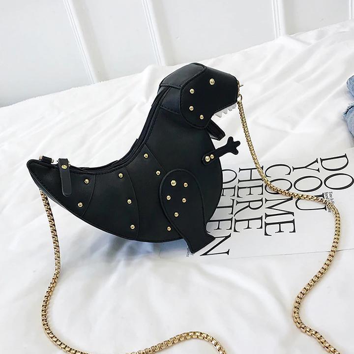 Schwarze Dinosaurier-Handtasche aus Leder mit goldener Kette, modisches Accessoire.