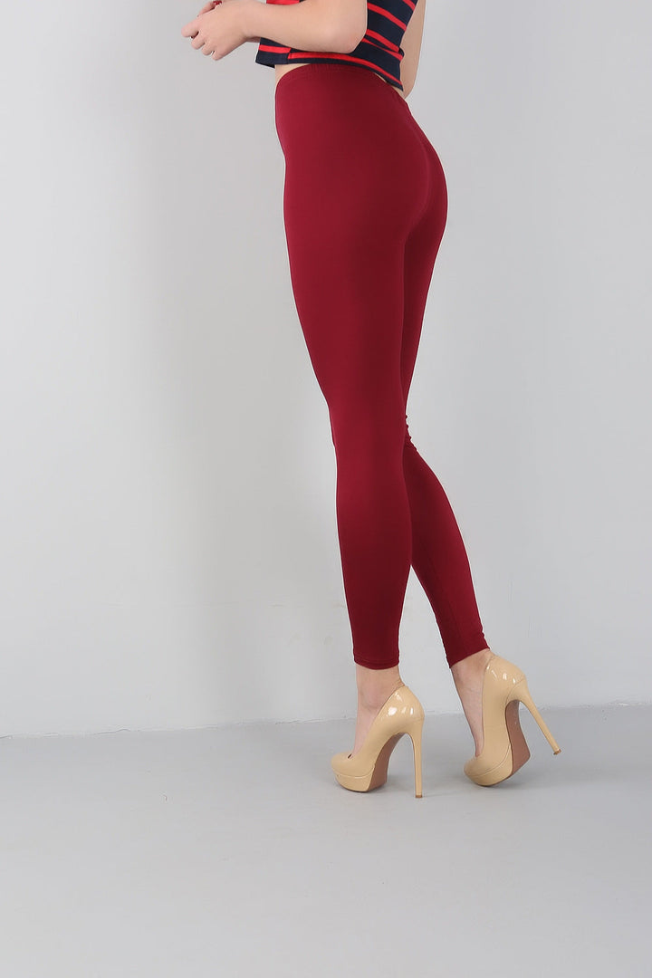 Frau in roten Leggings und beigen High Heels, gestreiftes Oberteil, Mode, Damenbekleidung.