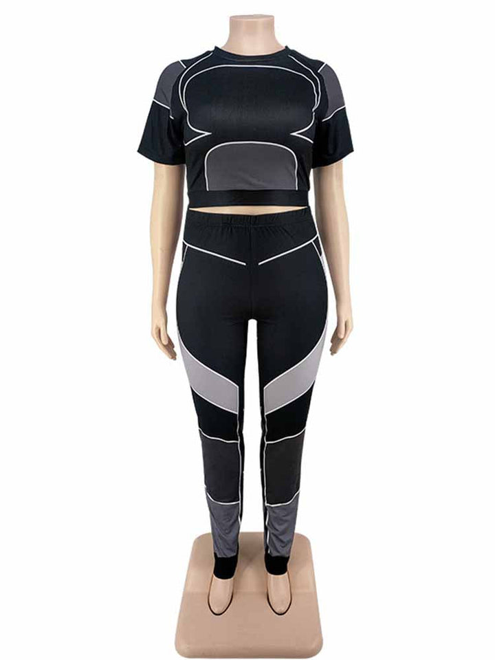 Schwarzes Damen-Sportset, kurzärmeliges Oberteil und Leggings, mit grauen Akzenten.