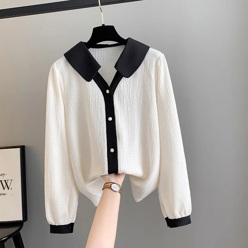 Weiße Bluse mit schwarzem Kragen, Knopfleiste, langen Ärmeln, elegantes Damenoberteil.