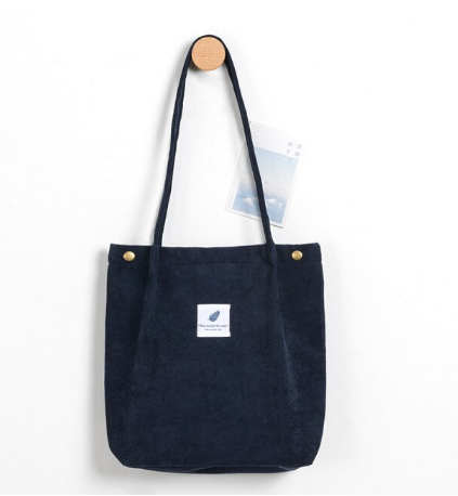 Dunkelblaue Stofftasche mit langen Henkeln, minimalistisches Design, Baumwolle, Alltagsgebrauch.