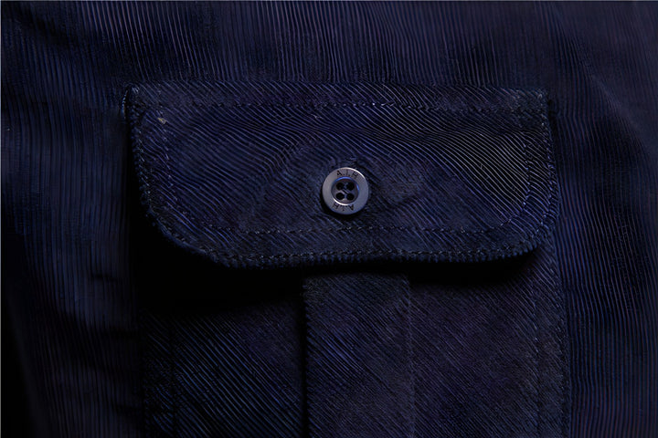 Dunkelblaue Jackentasche mit Knopf, Cordstoff, modisches Design, Detailaufnahme.