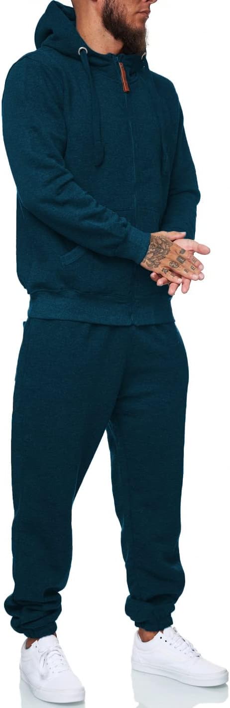 Mann in dunkelblauem Kapuzenpullover und Jogginghose, weiße Sneaker, Freizeitmode.