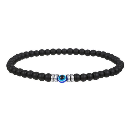 Schwarzes Perlenarmband mit blauem Auge, silberne Akzente, Unisex-Schmuck, modisch.