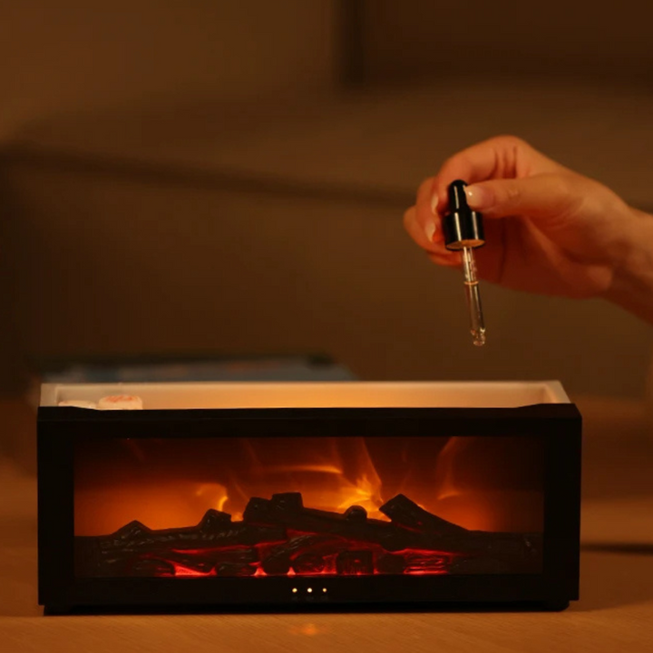 Hand hält Pipette über elektrische Duftlampe mit Flammeneffekt, schwarz, Aromatherapie.
