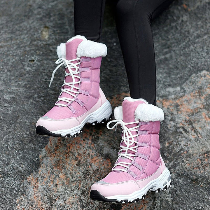 Rosa Damen-Winterstiefel mit weißem Kunstfell, rutschfeste Sohle, ideal für kaltes Wetter.